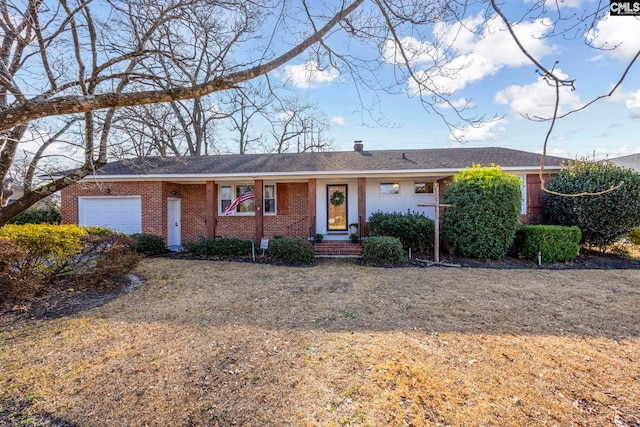 single story home featuring a garage and a front lawn