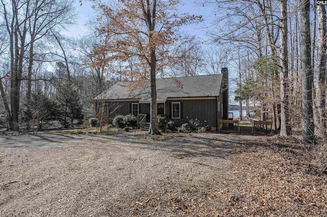 view of front of property with driveway and a chimney