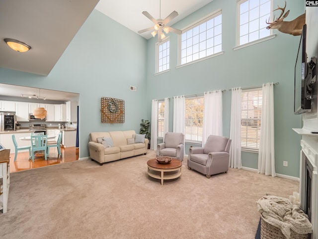 living room with light carpet and ceiling fan