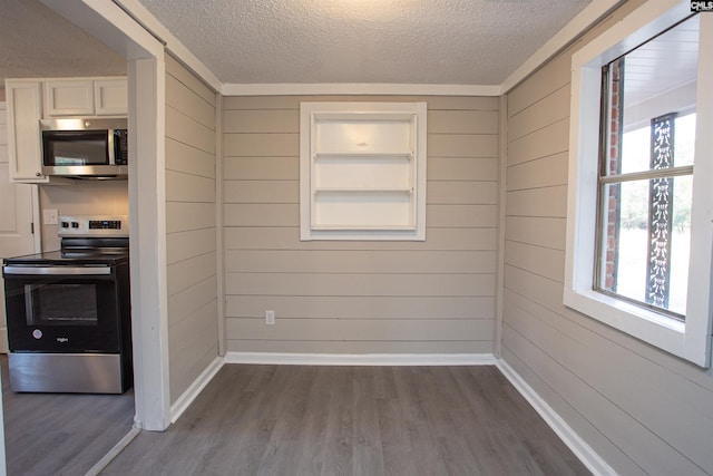 interior space with stainless steel appliances, a healthy amount of sunlight, and dark hardwood / wood-style floors