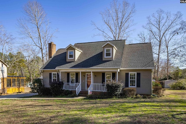 cape cod-style house with a porch and a front yard