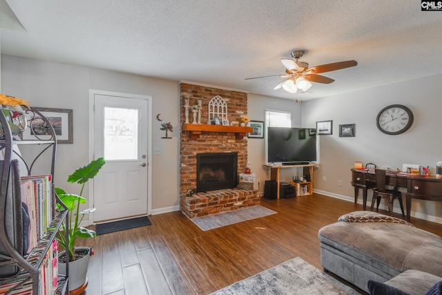 living room with plenty of natural light, dark wood-type flooring, and ceiling fan