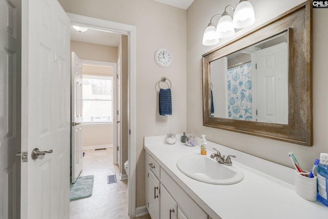 bathroom featuring vanity and toilet