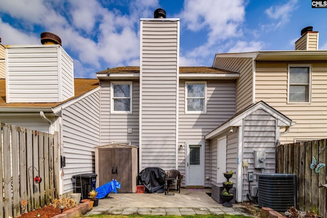 back of property featuring central AC and a patio area