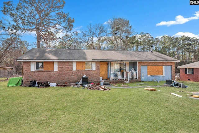 back of property featuring a porch and a lawn