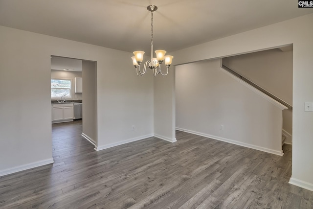 unfurnished dining area with hardwood / wood-style flooring, a chandelier, and sink