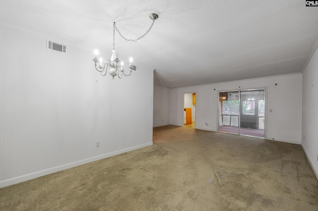 carpeted empty room featuring a notable chandelier, crown molding, and a textured ceiling