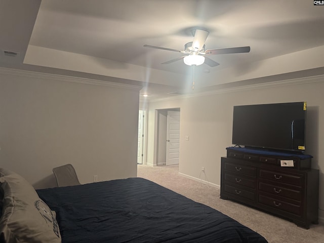 bedroom featuring crown molding, ceiling fan, a raised ceiling, and light carpet