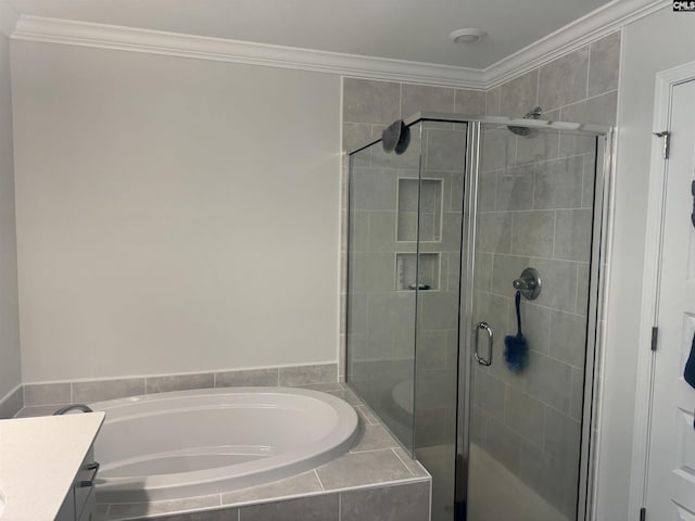 bathroom with vanity, ornamental molding, and shower with separate bathtub