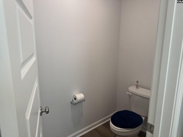 bathroom with wood-type flooring and toilet