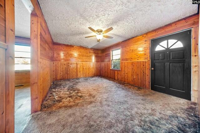 104 Brandon Rd, Clinton, SC 29325 - foyer entrance featuring ceiling fan, wooden walls, carpet flooring, and a textured ceiling