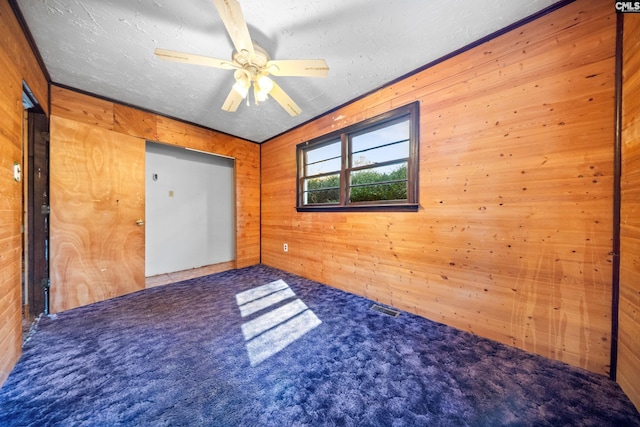 104 Brandon Rd, Clinton, SC 29325 - carpeted empty room featuring a textured ceiling, ceiling fan, and wood walls