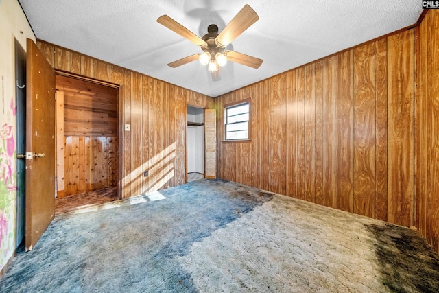 104 Brandon Rd, Clinton, SC 29325 - unfurnished bedroom with ceiling fan, carpet, a textured ceiling, and wooden walls
