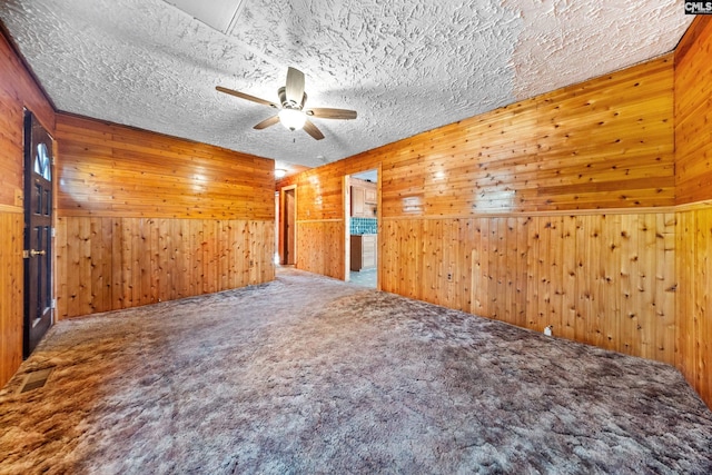 104 Brandon Rd, Clinton, SC 29325 - carpeted spare room with ceiling fan, wooden walls, and a textured ceiling