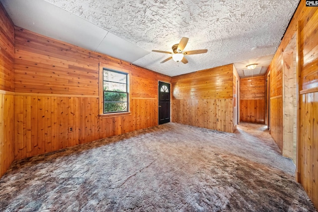 104 Brandon Rd, Clinton, SC 29325 - unfurnished room featuring ceiling fan, carpet flooring, wooden walls, and a textured ceiling