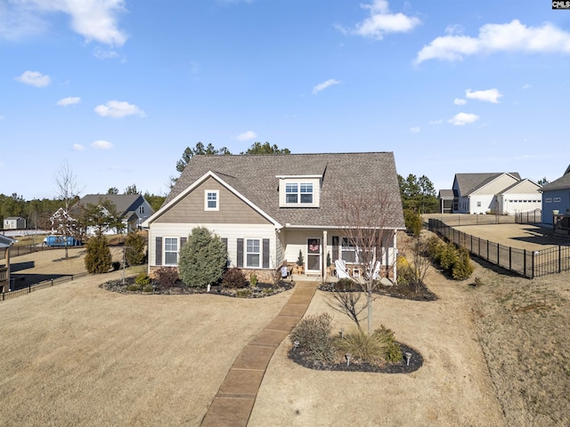 view of front of home with a front yard and covered porch