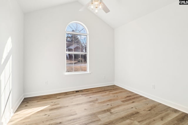 spare room with lofted ceiling, ceiling fan, and light wood-type flooring