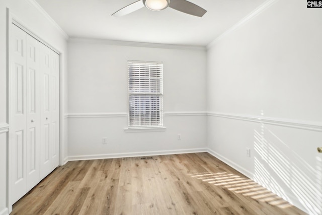 unfurnished bedroom featuring crown molding, ceiling fan, light hardwood / wood-style floors, and a closet