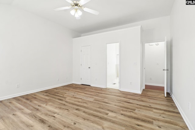 unfurnished bedroom featuring ceiling fan, connected bathroom, and light wood-type flooring