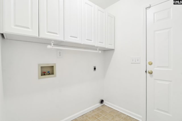 laundry room featuring electric dryer hookup, hookup for a washing machine, and cabinets