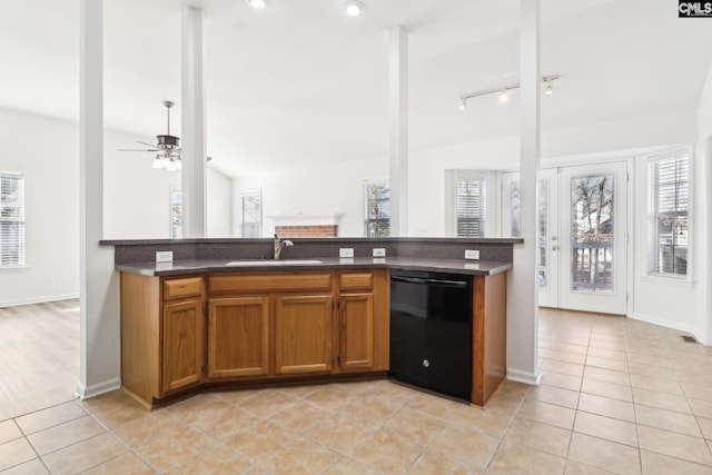 kitchen featuring sink, black dishwasher, a wealth of natural light, and light tile patterned floors