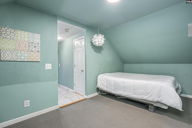 bedroom with vaulted ceiling and light carpet