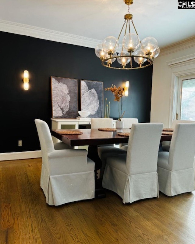 dining room with a notable chandelier, crown molding, and wood-type flooring