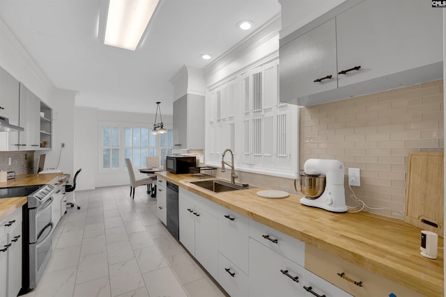 kitchen with pendant lighting, sink, black appliances, white cabinets, and wood counters