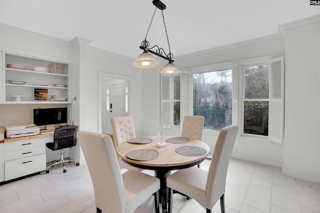 dining room featuring built in features, built in desk, and ornamental molding