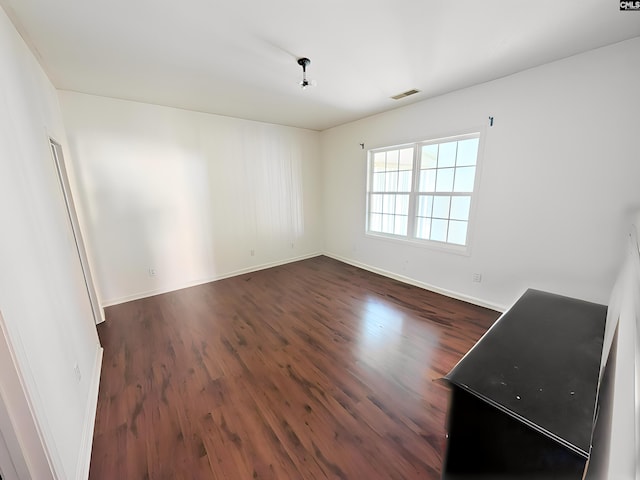 empty room featuring dark hardwood / wood-style flooring