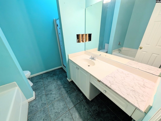 bathroom with vanity, a washtub, and toilet