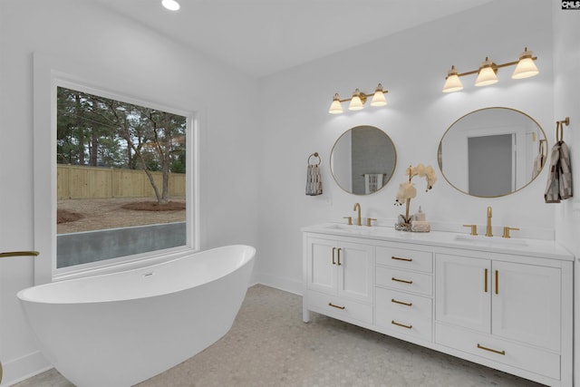 bathroom featuring vanity and a tub