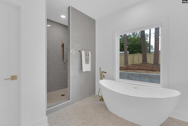 bathroom with shower with separate bathtub