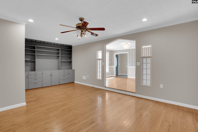 unfurnished bedroom featuring crown molding, light hardwood / wood-style flooring, and ceiling fan