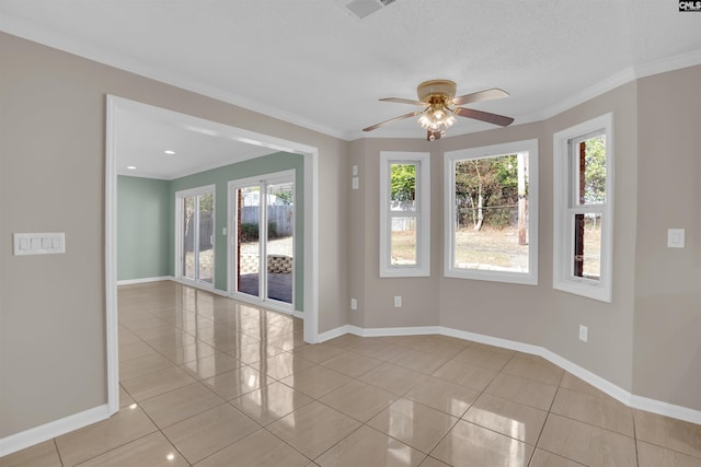 tiled empty room with crown molding, a textured ceiling, and ceiling fan