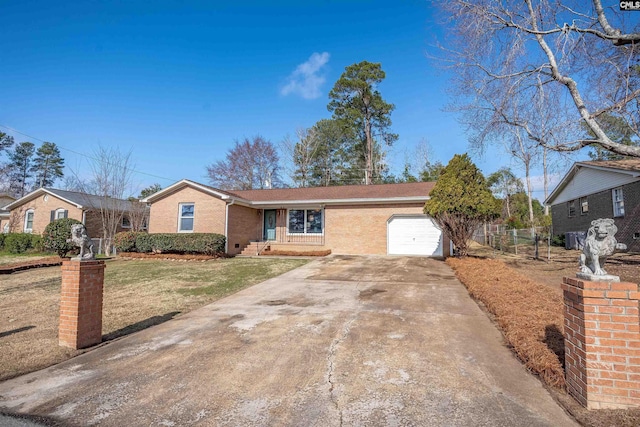 single story home featuring a garage and a front yard