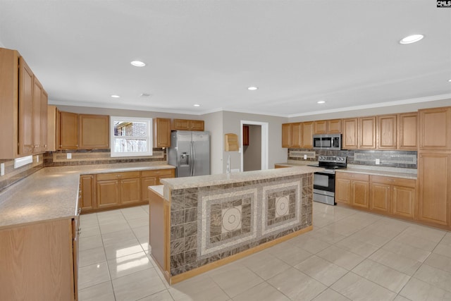 kitchen featuring appliances with stainless steel finishes, tasteful backsplash, ornamental molding, a center island, and light tile patterned floors