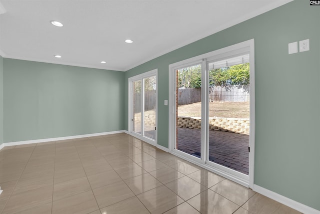 tiled spare room featuring ornamental molding