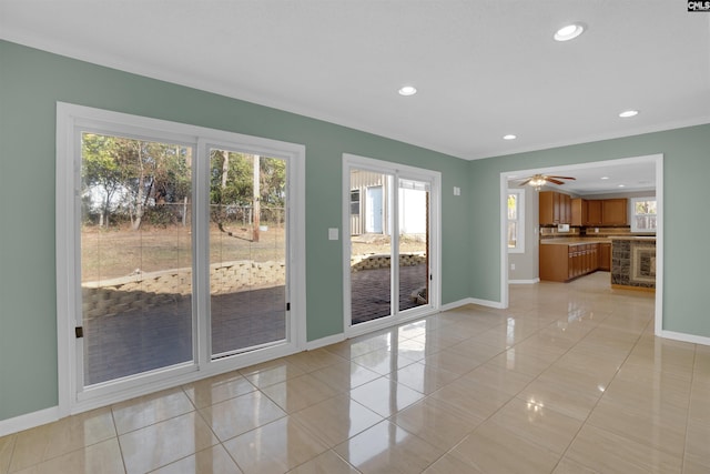 interior space with light tile patterned flooring and ceiling fan