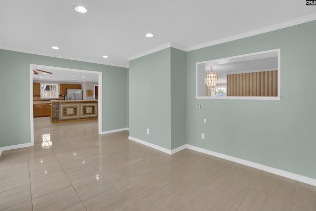 spare room with crown molding, a chandelier, and light tile patterned floors