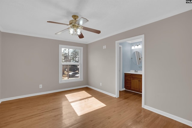 unfurnished bedroom with ceiling fan, ensuite bath, ornamental molding, and light hardwood / wood-style flooring