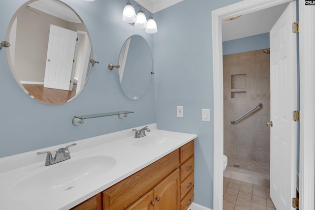 bathroom with vanity, tile patterned floors, toilet, and tiled shower