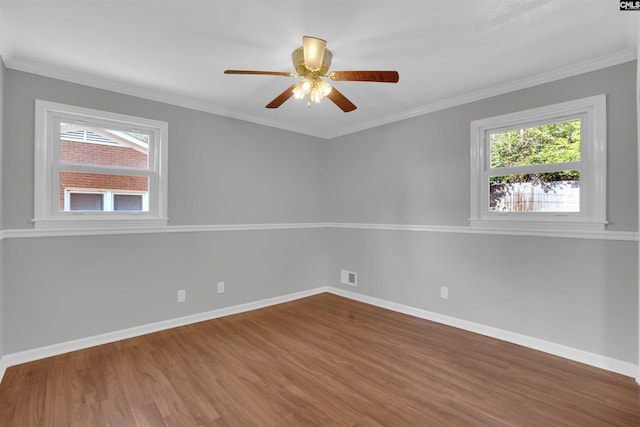 spare room with hardwood / wood-style floors, ornamental molding, and ceiling fan