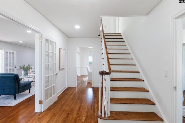 stairway featuring hardwood / wood-style floors and french doors