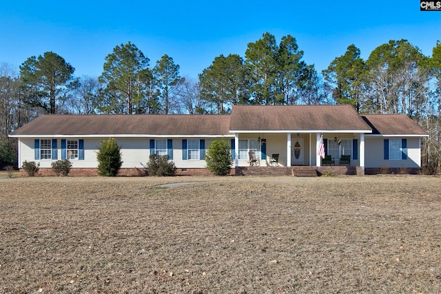 ranch-style house with covered porch and a front lawn