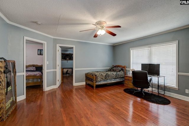 bedroom featuring crown molding, wood-type flooring, and a textured ceiling