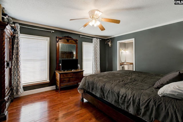 bedroom with connected bathroom, crown molding, a textured ceiling, ceiling fan, and hardwood / wood-style floors