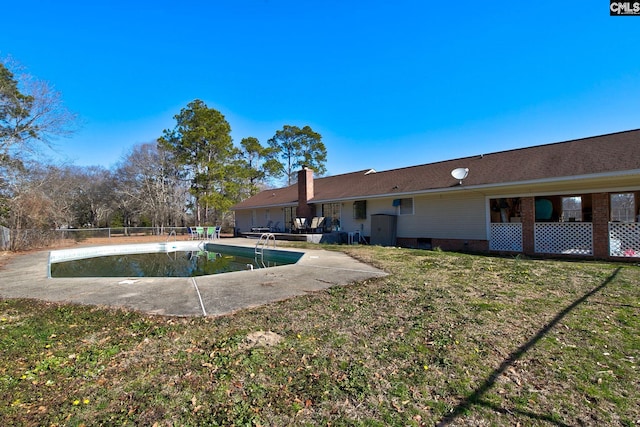 view of pool featuring a patio and a yard