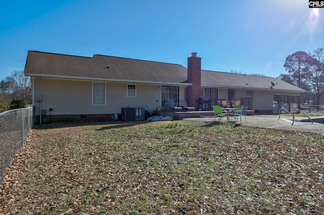 rear view of property featuring central AC unit and a patio area