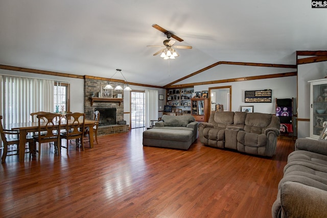 living room featuring ceiling fan, lofted ceiling, hardwood / wood-style floors, and a brick fireplace